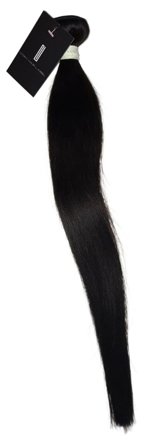 Black hair extension with a label on a light gray background